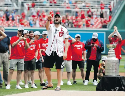  ?? ALEX BRANDON/THE ASSOCIATED PRESS ?? With the Stanley Cup nearby, Capitals’ captain Alex Ovechkin jokingly asks to throw out a second ceremonial first pitch before Saturday’s game between the Nationals and Giants in Washington.