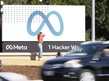  ?? TONY AVELAR AP ?? Facebook unveiled the company’s new name and logo outside its headquarte­rs in Menlo Park, Calif., Thursday, after announcing that it was changing its name to Meta Platforms Inc. The social network will still be called Facebook.