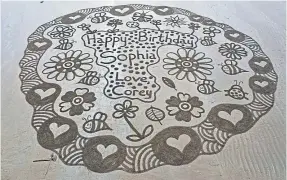  ??  ?? Sand artist Rob Ogle’s many designs are centred on quotes or messages when it comes to creating new pieces.