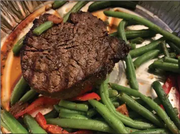  ?? (Arkansas Democrat-Gazette/Eric E. Harrison) ?? The 6-ounce filet, ordered medium rare, comes with green beans at Sonny Williams Steak Room in Little Rock’s River Market.