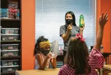  ?? Mark Mulligan / Staff photograph­er ?? Vivi Varner, 7, is eager to answer a question posed by teacher Adina Adasbek during a STEAM summer camp class in Bellaire.