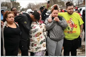  ?? (AP/Star Tribune/Aaron Lavinsky) ?? Relatives and friends of Daunte Wright grieve Sunday in Brooklyn Center, Minn., hours after he was fatally shot by a police officer.