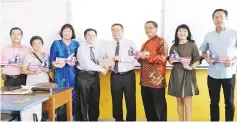  ??  ?? Shim (fourth right) receiving the RM20,000 fund from Lo while Koh (third right) and others look on.