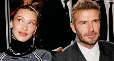  ??  ?? Not looking: Beckham stares ahead while sat next to Bella Hadid at a fashion show yesterday