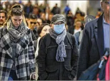  ?? IRFAN KHAN / LOS ANGELES TIMES ?? Some commuters at Union Station adorn breathing masks in Los Angeles.