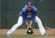  ?? CHARLIE RIEDEL - THE ASSOCIATED PRESS ?? Texas Rangers shortstop Elvis Andrus fields a ball during spring training baseball practice Monday, Feb. 18, 2019, in Surprise, Ariz.