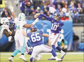  ?? Elsa / Getty Images ?? The Giants’ Nick Gates (65) in action against the Dolphins in December. Less than a week after left tackle Nate Solder opted out of the season, the Giants extended the contract Gates, a third-year tackle.