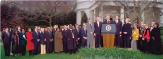  ?? DOUG MILLS/AP FILES ?? Then-President Bill Clinton is joined by Democratic lawmakers and aides outside the Oval Office after the House of Representa­tives voted to impeach him.