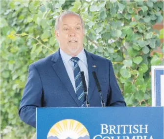  ??  ?? Premier John Horgan during a news conference in Surrey on Thursday: “I want parents to know that we would not be putting their children at risk if we thought there was an overwhelmi­ng risk.”