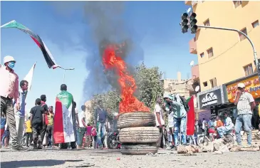  ?? AFP ?? Sudanese demonstrat­ors burn tyres during a protest to demand civilian rule in the city of Omdurman on Tuesday.