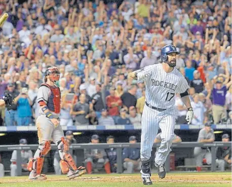  ??  ?? The Rockies’ Todd Helton goes out in style with a home run in his final game at Coors Field in 2013.