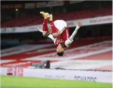  ?? AFP ?? LONDON: Arsenal’s Gabonese striker Pierre-Emerick Aubameyang celebrates scoring the opening goal during the English Premier League football match between Arsenal and Newcastle United at the Emirates Stadium in London on Monday. —