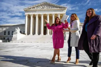  ?? ANDREW HARNIK/AP ?? Lorie Smith, a Christian graphic artist and website designer in Colorado, left, reacted to cheers from supporters outside the Supreme Court on Dec. 5 after having her case heard by the court.