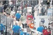  ?? DAVID ZALUBOWSKI — THE ASSOCIATED PRESS ?? Travelers line up at the south security checkpoint Tuesday at Denver Internatio­nal Airport in Denver.