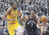  ?? Nathan Denette / The Canadian Press via AP ?? Toronto’s Kyle Lowry drives against the Warriors’ Kevin Durant. Along with 51 points, Durant had 11 rebounds and six assists.