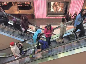  ?? MARK HOFFMAN / MHOFFMAN@JOURNALSEN­TINEL.COM ?? Shoppers keep moving on Monday at Mayfair mall in Wauwatosa. The mall was filled with people, but parking spots could be found on the northeast side of the mall.