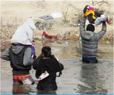  ?? — AFP ?? CIUDAD JUAREZ: Migrants cross the Rio Bravo river, known as Rio Grande in the United States, into the US through Mexico, on Jan 2, 2024.