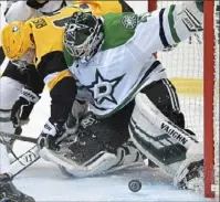  ??  ?? Bryan Rust battles for loose puck in front of Stars goalie Landon Bow.