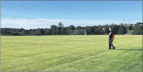  ?? SUBMITTED PHOTO ?? Chris Karnchanap­hati stands on the newly opened JK Memorial Field in Washington Township that honors the memory of his son, Jacob “JK” Karnchanap­hati, 12, of Gilbertsvi­lle, who passed away in the summer of 2015. Jacob was an active member of the Boyertown Soccer Club.