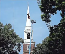  ??  ?? Workers begin removing a 14-story steeple atop the former Evergreen Presbyteri­an Church, which is now an academic facility for Rhodes College. MARK WEBER / THE COMMERCIAL APPEAL