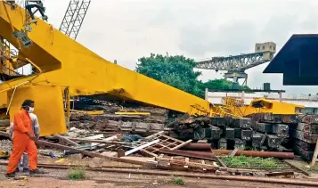  ??  ?? Workers search for bodies at the site where a huge crane collapsed inside the Hindustan Shipyard in Visakhapat­nam on Saturday.