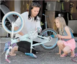  ?? CATHIE COWARD THE HAMILTON SPECTATOR ?? Ali Noble and daughter, Gwen, who is in Grade 1. Ali has given up on online learning for her daughter and is mostly educating her about the “school of life” — teaching her how to tie her shoes, how to bake, how to fix a busted bike chain (which she did Thursday).