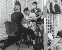  ?? Jessica Phelps/staff photograph­er ?? A client works with her physical therapist and others at the new Multiassis­tance Center. The MAC is a potential game changer for families caring for loved ones with special needs.