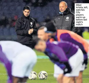  ??  ?? Mikel Arteta, left, watches City players warm-up before last night’s match