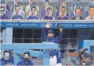  ?? [MARK J. TERRILL/ASSOCIATED PRESS] ?? Cutouts of spectators populate the stands as Dodgers manager Dave Roberts gestures to home plate umpire D.J. Reyburn after their exhibition game against the Angels on Tuesday in Los Angeles.