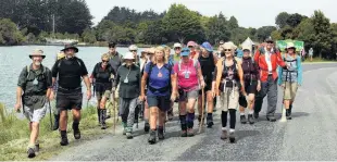  ??  ?? Making new memories . . . Trail boss Sandra Cain leads a walking trail out of Pounawea yesterday on the final leg to the Cavalcade finish.