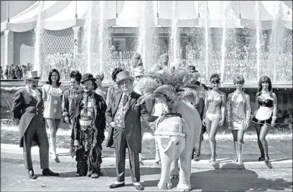  ?? Las Vegas News Bureau ?? Circus Circus developer Jay Sarno, Las Vegas’ version of P.T. Barnum, is joined by some of his cast of performers in 1968.