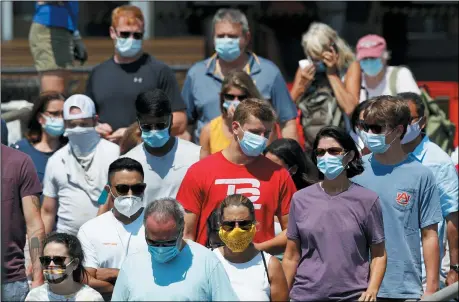  ?? THE ASSOCIATED PRESS ?? Passengers boards a Casco Bay Lines ferry bound for Peaks Island, July 30, in Portland, Maine. State officials reported more cases of COVID-19.