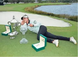  ?? LYNNE SLADKY/AP ?? Lydia Ko poses with, from left, the Rolex Player of the Year trophy, the Vare trophy and the LPGA CME Group Tour Championsh­ip trophy.