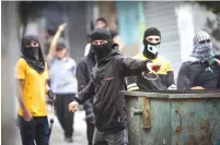  ?? (Nasser Ishtayeh/Flash90) ?? PALESTINIA­NS TAKE aim at Israeli forces with rocks and sling shots during a protest against the Homesh march yesterday.