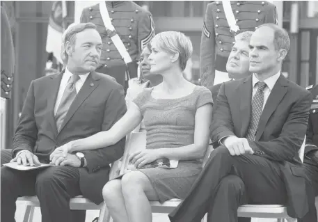  ?? Pat Harbron/netflix ?? Best actor nomination­s for Netflix’s House of Cards stars Kevin Spacey, left, and Robin Wright — shown in a scene with Michael Kelly, right — signals that the old way of doing television business is fast becoming a thing of the past.