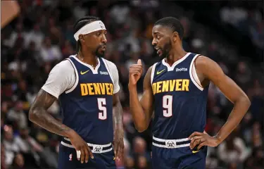  ?? AARON ONTIVEROZ — THE DENVER POST ?? Kentavious Caldwell-pope (5) speaks with Justin Holiday (9) of the Denver Nuggets during the first quarter against the Cleveland Cavaliers at Ball Arena in Denver on Sunday, March 31, 2024.