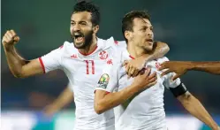  ?? Ariel Schalit/Associated Press ?? ■ Tunisia’s Youssef Msakni, right and Tunisia’s Taha Khenissi celebrate after scoring during the African Cup of Nations quarterfin­al soccer match Thursday between Madagascar and Tunisia in Cairo, Egypt. Tunisia defeated Madagascar, 3-0.