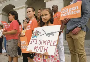  ?? RICH PEDRONCELL­I/AP ?? Elise Schering, 7, takes part in a National Gun Violence Awareness Day rally Thursday in Sacramento, Calif.