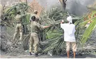 ??  ?? British Marines help with the post-hurricane clean-up on Tortola, biggest of the British Virgin Islands