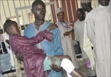  ?? Olu Ajayi/Associated Press ?? A victim of an army drone attack receives treatment Tuesday at a hospital in Kaduna Nigeria. Nigeria's emergency services agency says more than 85 people are confirmed dead after military drones “mistakenly” bombed a religious gathering in the northwest.