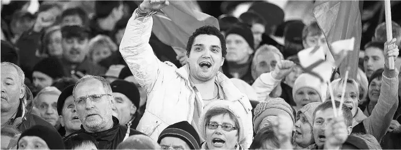  ?? Sean Galup / Gett
y Images ?? People waving Russian flags cheer the March 6 confirmati­on by the Sevastopol regional council that it supports Crimea seceding from Ukraine and joining Russia.