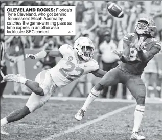  ?? AP ?? CLEVELAND ROCKS: Florida’s Tyrie Cleveland, who got behind Tennessee’s Micah Abernathy, catches the game-winning pass as time expires in an otherwise lackluster SEC contest.