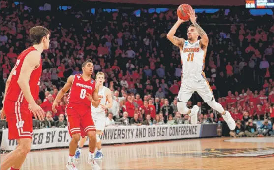  ?? | MADDIE MEYER/ GETTY IMAGES ?? Chris Chiozza hit a three- pointer at the buzzer to beat Wisconsin in overtime Friday in the East Regional semifinal at Madison Square Garden.