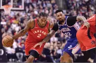  ?? CP PHOTO / FRANK GUNN ?? Toronto Raptors forward Kawhi Leonard (2) moves pass Philadelph­ia 76ers forward Wilson Chandler (22) during first half NBA basketball action in Toronto on Wednesday.