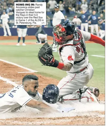  ?? UPI ?? HOME-ING IN: Randy Arozarena slides past catcher Christian Vazquez to steal home for the Rays in their 5-0 victory over the Red Sox in Game 1 of the ALDS in St. Petersburg, Fla.