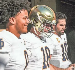  ?? KEN RUINARD-USA TODAY SPORTS ?? Notre Dame quarterbac­k Kenny Minchey (8), quarterbac­k Steve Angeli (18) and starting quarterbac­k Sam Hartman (10) enter the field before the game with Clemson Nov 4, 2023; Clemson, South Carolina, USA; at Memorial Stadium.