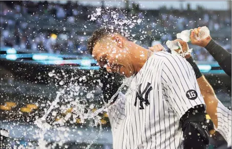  ?? Mike Stobe / Getty Images ?? The Yankees’ Aaron Judge celebrates after hitting a walk-off single in the bottom of the ninth inning to beat the Rays on Sunday and clinch a playoff berth.