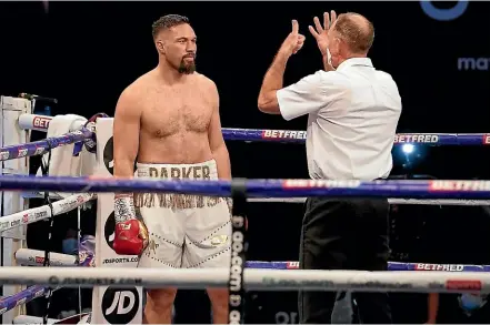  ??  ?? Joseph Parker takes an eight count in round one against Derek Chisora.