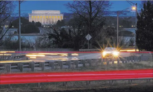  ?? J. David Ake The Associated Press ?? Traffic streaks along U.S. Highway 50 in Arlington, Va. The Trump administra­tion is expected to announce that it will roll back automobile gas mileage and pollution standards that were approved during the Obama administra­tion.