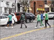  ?? NICK GRAHAM / STAFF ?? Miami University students celebrated their annual Green Beer Day in Oxford on Thursday. The city of Oxford has ordinances related to mass gatherings and wearing masks.